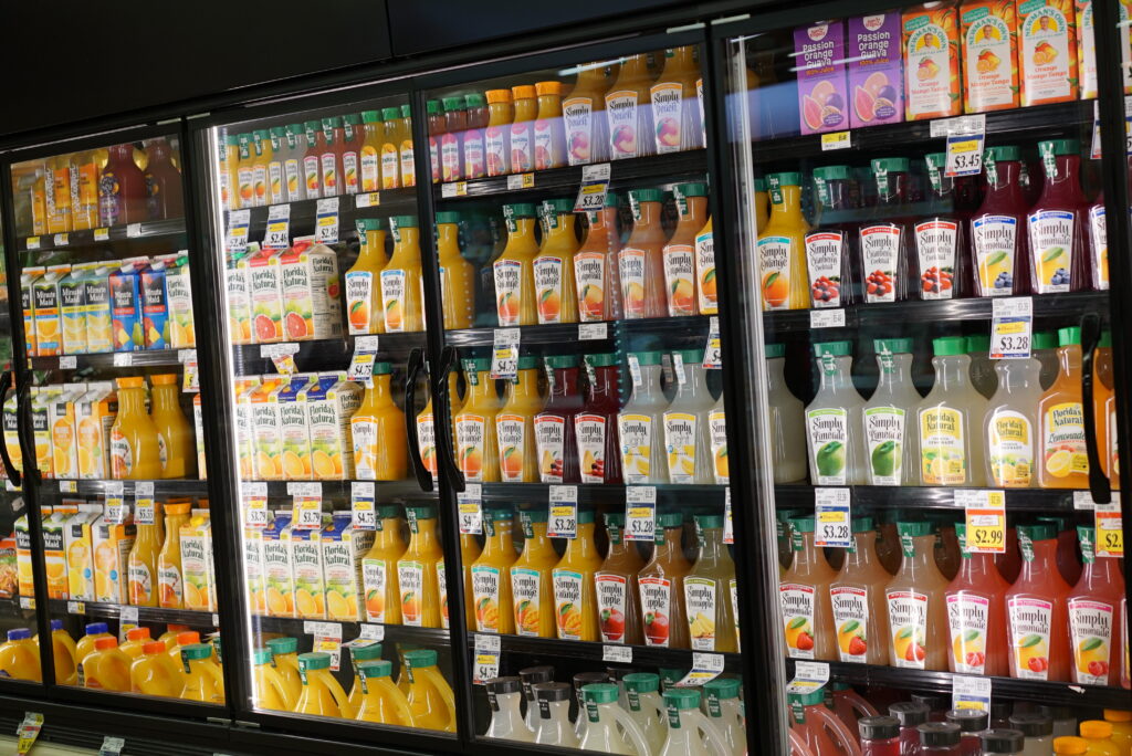 Grocery store refrigerated case with closed doors for energy conservation